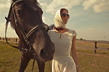 Beautiful girl in a white gown with horse on nature clipart