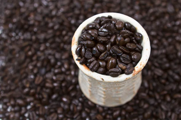 Coffee cup with whole beans — Stock Photo, Image