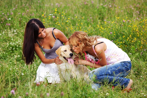Girlfriends and dog Stock Photo