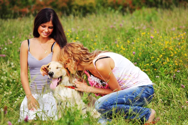 Girlfriends and dog Stock Image