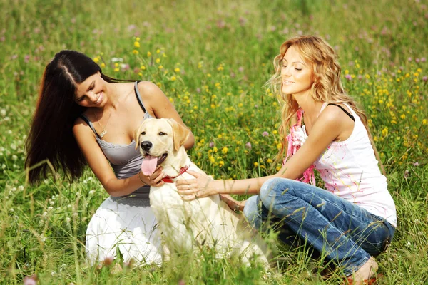Girlfriends and dog — Stock Photo, Image