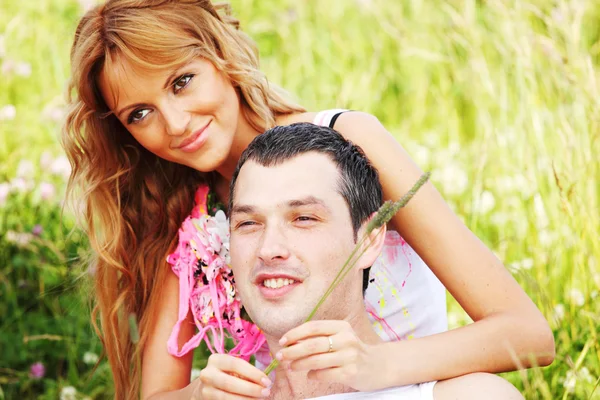 Lovers on grass field — Stock Photo, Image