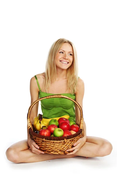 Woman holds a basket of fruit — Stock Photo, Image