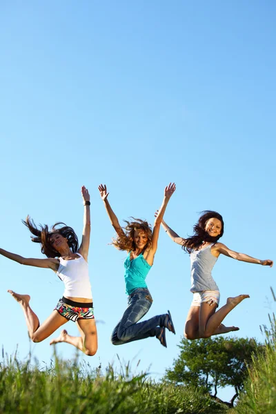 Girlfriends jump Stock Photo