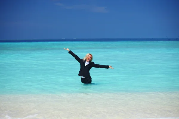 Business woman in ocean — Stock Photo, Image