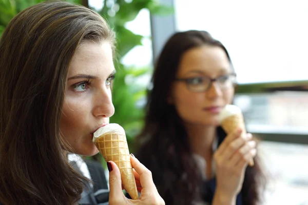 Happy women licking ice cream — Stock Photo, Image