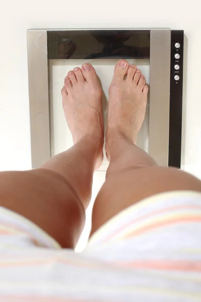 Legs on scales — Stock Photo, Image