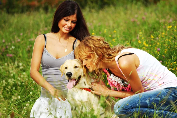 Girlfriends and dog Stock Photo