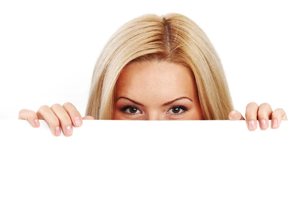 Kvinna gömd bakom papper Stockfoto