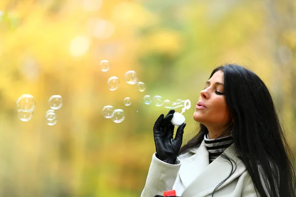 Autumn woman blow bubbles — Stock Photo, Image