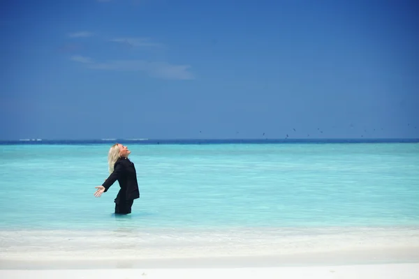 Business woman in ocean — Stock Photo, Image