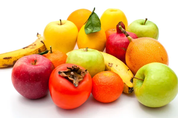 stock image A lot of different fruits and green leaves on white background