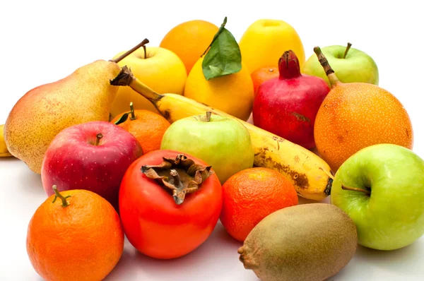 stock image A lot of different fruits and green leaves on white background