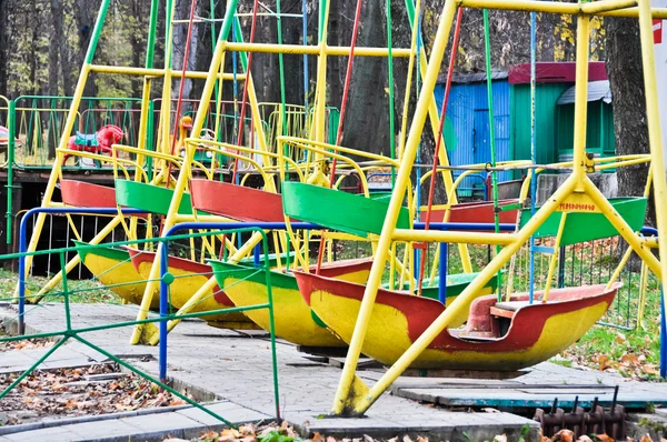 Swing boats in the old amusement park — Stock Photo, Image