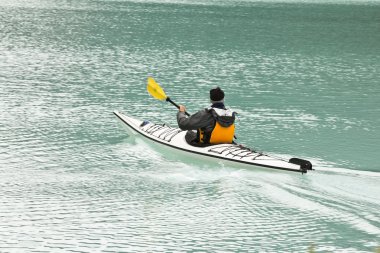 Canoeing on the magnificent Lake Louis clipart