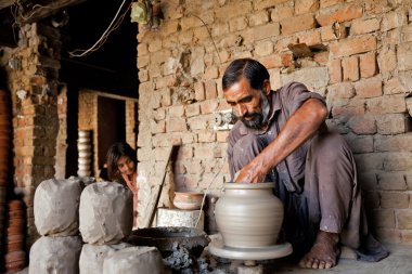 Potter making a terracotta vase clipart