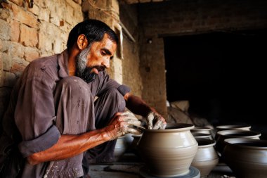 Potter making a terracotta vase clipart