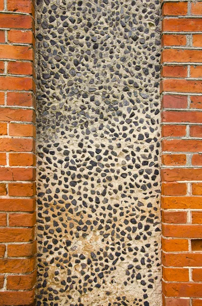Wall made of brick and concrete with little stones — Stok fotoğraf