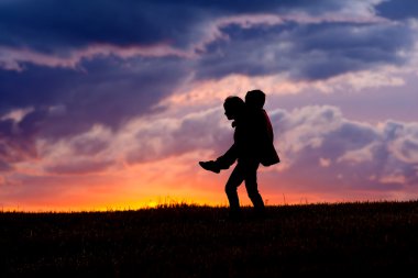 Girl carries her little brother. clipart