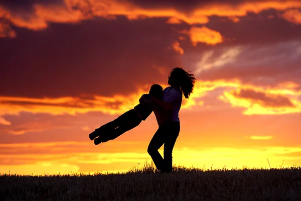 Swinging her son around. — Stock Photo, Image