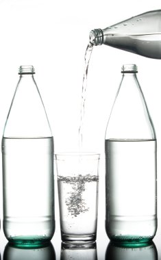 Pouring water from a bottle. clipart