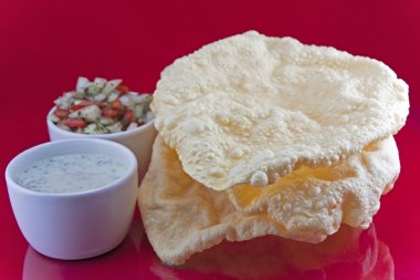 Poppadoms with onion salad and Mint Raita clipart