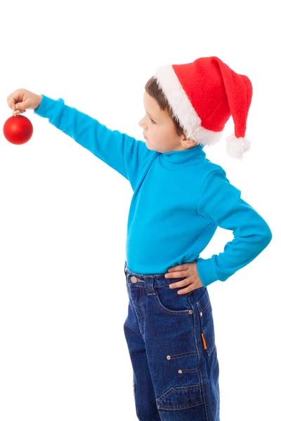 Kleiner Junge mit Weihnachtsmütze mit roter Dekoration — Stockfoto