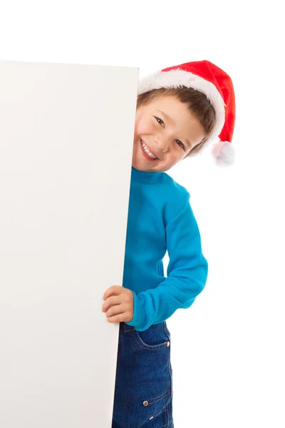 Garçon souriant dans le chapeau de Père Noël avec bannière vide — Photo