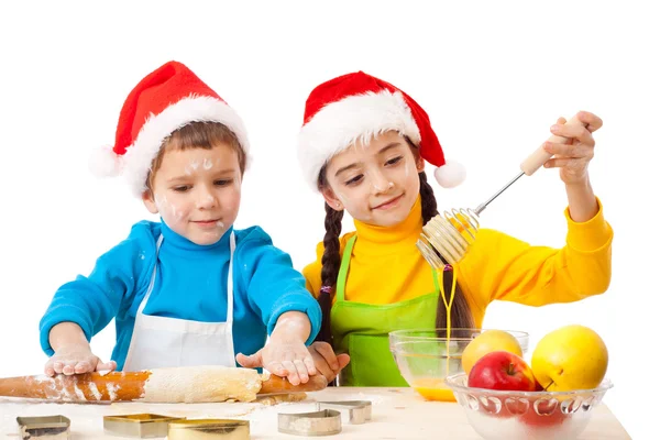 Двое улыбающихся детей с рождественской кухней — стоковое фото