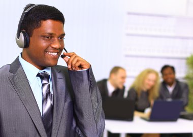 Interracial business team working at laptop in a modern office. clipart