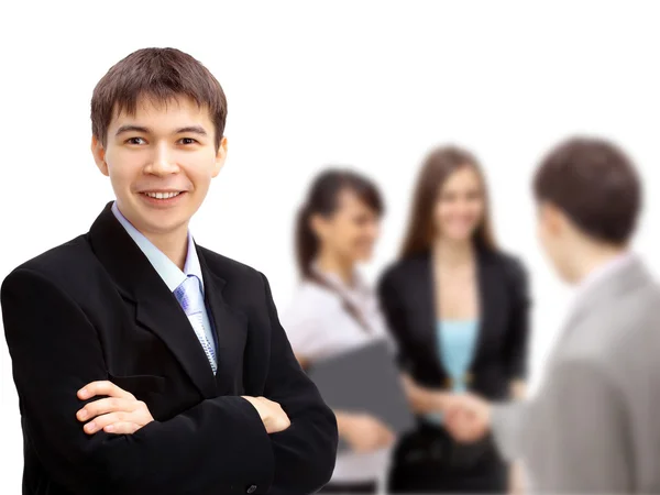 Business man with colleagues out of focus in background — Stock Photo, Image