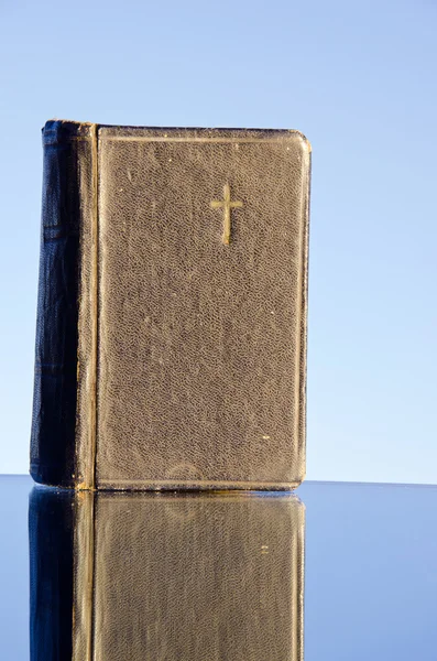 Old religious book on mirror — Stock Photo, Image