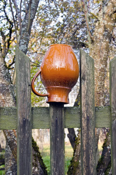 Кувшин на деревенском заборе — стоковое фото