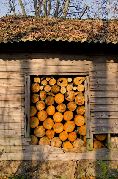 Autumn firewood in the old woodshed — Stock Photo, Image