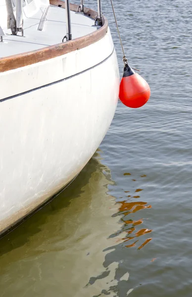 Yacht fragment with red buoy — Stock Photo, Image