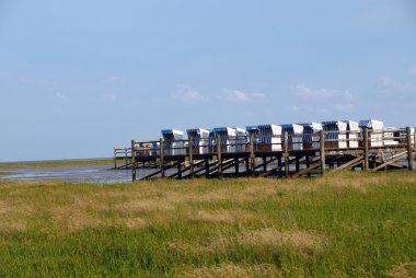 Roofed wicker beach chairs clipart