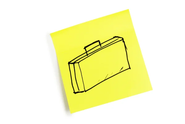 Hoja amarilla de papel con la imagen de una maleta — Foto de Stock