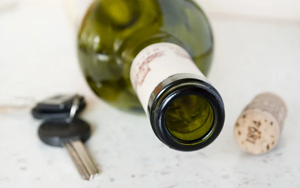 stock image Bottle of wine and cork keys on the table