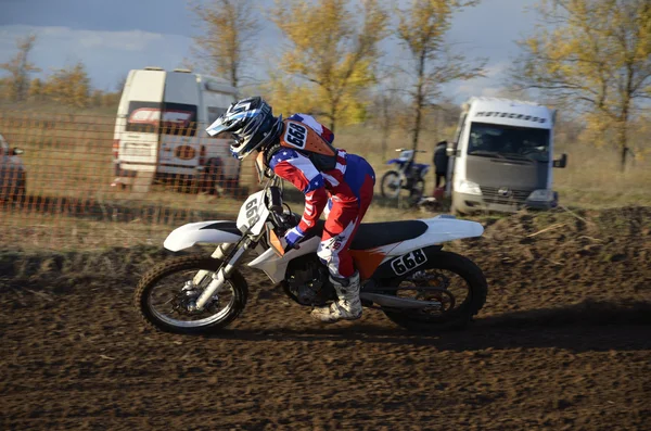 Motocross rider riding a turn standing