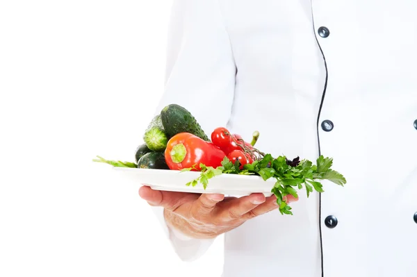 Chef holding plate with vegetables — Stock Photo, Image