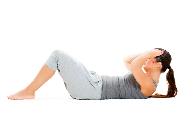 Girl doing exercises for abdominal muscles — Stock Photo, Image