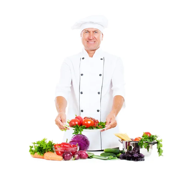 Hef holding plate with fresh vegetables — Stock Photo, Image