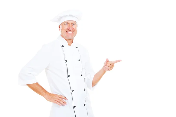 Chef sorridente che punta al copyspace — Foto Stock
