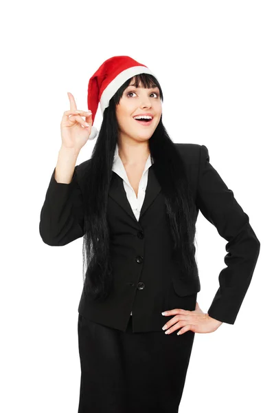 Glückliche Geschäftsfrau mit Weihnachtsmütze zeigt nach oben — Stockfoto