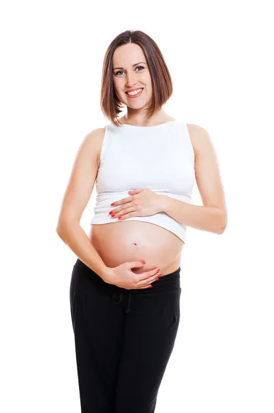 Schöne schwangere Frau umarmt ihren Bauch — Stockfoto