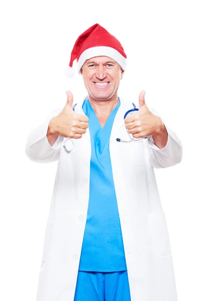 Arzt mit roter Weihnachtsmütze zeigt Daumen hoch — Stockfoto