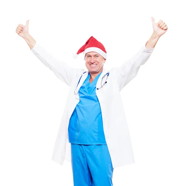 Doctor en sombrero rojo de Navidad mostrando los pulgares hacia arriba — Foto de Stock