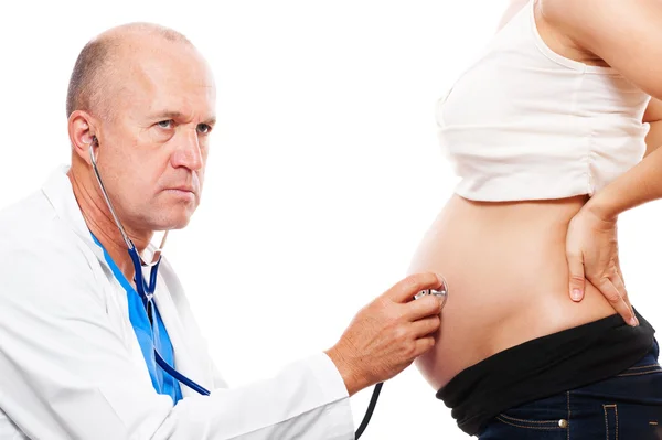 Doctor listening pregnant woman's belly — Stock Photo, Image