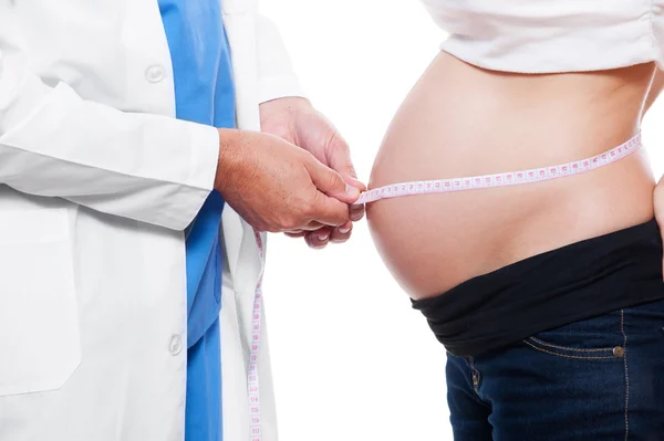 Doctor measuring stomach at pregnant woman — Stock Photo, Image