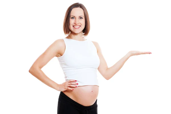 Kobieta w ciąży trzyma coś na jej dłoni — Zdjęcie stockowe